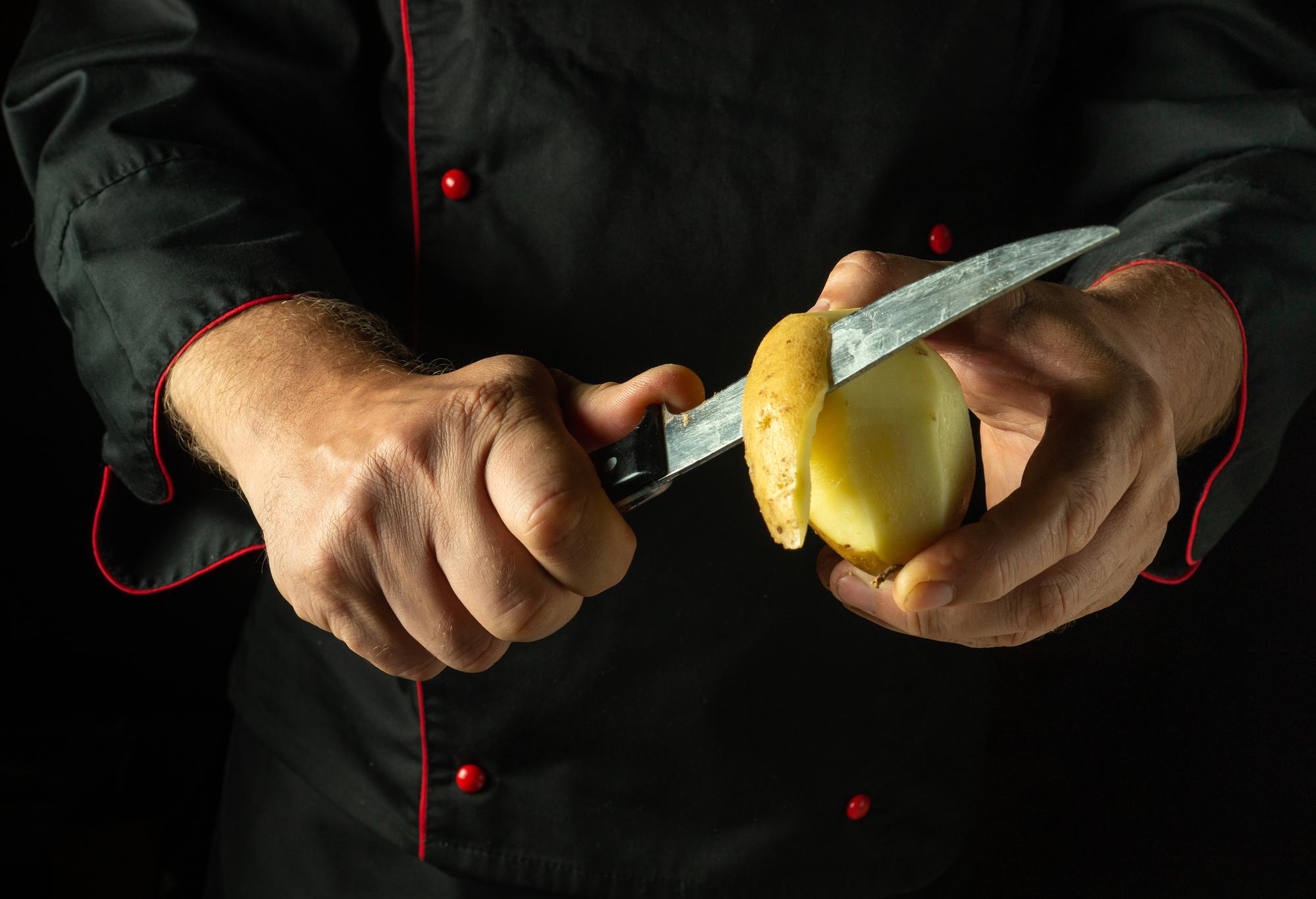 Chef demonstrating knife skills to camera